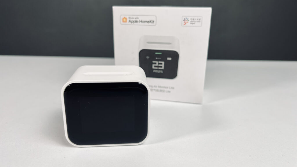 QingPing Air Monitor Lite on white surface with its packaging