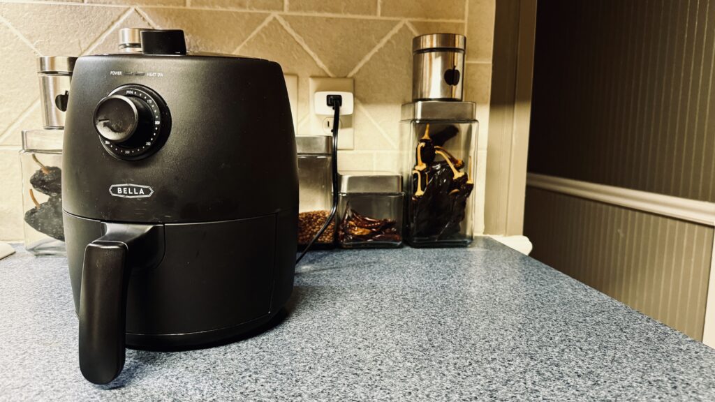 a small air fryer plugged into at the S4 on a kitchen countertop